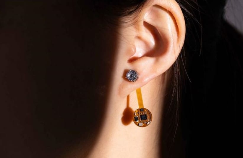  University of Washington researchers introduced the thermal earring, a wireless wearable that continuously monitors a user’s earlobe temperature. (photo credit: Raymond Smith/University of Washington)