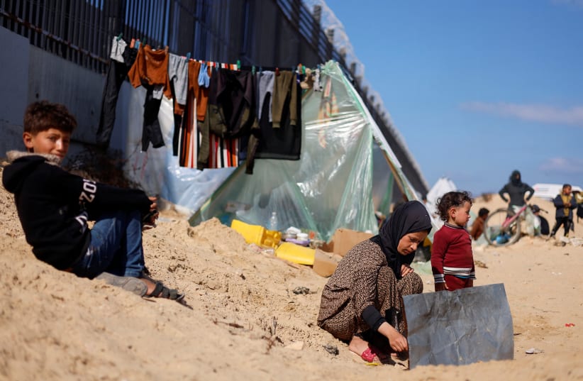  Displaced Palestinian woman Laila Abu Mustafa, who fled her house due to Israeli strikes, shelters at the border with Egypt, in Rafah in the southern Gaza Strip, February 10, 2024. (photo credit: REUTERS/MOHAMMED SALEM)