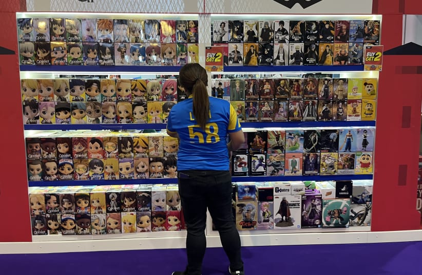 A salesperson at The Middle East Film & Comic Con in the United Arab Emirates.  (photo credit: Omnia Al Desoukie/The Media Line)