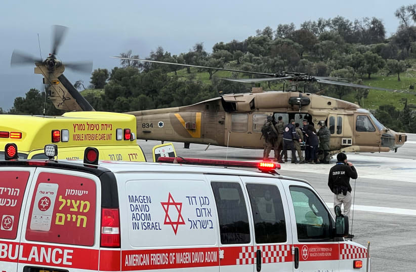  Israeli officials evacuate a person who was injured by a rocket that landed after it was fired from Lebanon, amid the ongoing conflict between Israel and the Palestinian Islamist group Hamas, in Safed, northern Israel February 14, 2024 (photo credit: REUTERS/Avi Ohayon)