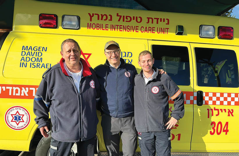  DR. JOSH SHATZKES (center) with one of the teams he worked with and their ambulance.  (photo credit: Courtesy Josh Shatzkes)