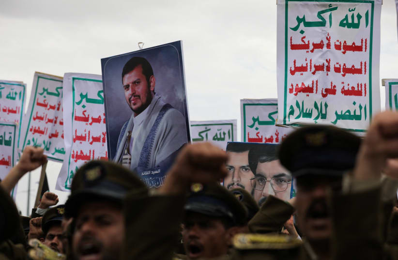  Demonstrators, predominantly Houthi supporters, hold a picture of the Houthi leader Abdul-Malik al-Houthi and signs as they rally to show support to the Palestinians in the Gaza Strip, amid the ongoing conflict between Israel and the Palestinian Islamist group Hamas, in Sanaa, Yemen February 16, 20 (photo credit: KHALED ABDULLAH/REUTERS)