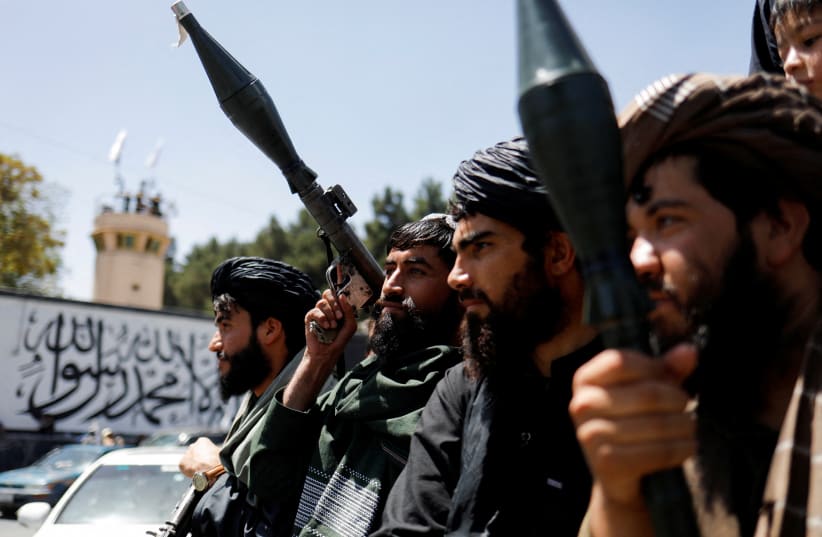  Taliban fighters celebrate on the second anniversary of the fall of Kabul on a street near the US embassy in Kabul, Afghanistan, August 15, 2023. (photo credit: REUTERS)