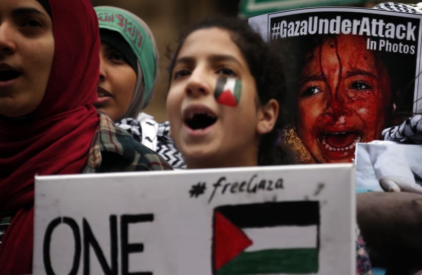  Members of the Australian Palestinian community holds flags and chant slogans as they participate in a protest against Israel's military action in Gaza, in Sydney July 20, 2014. Israel said on Sunday it had expanded its ground offensive in Gaza and militants kept up rocket fire into the Jewish stat (photo credit: David Gray/Reuters)