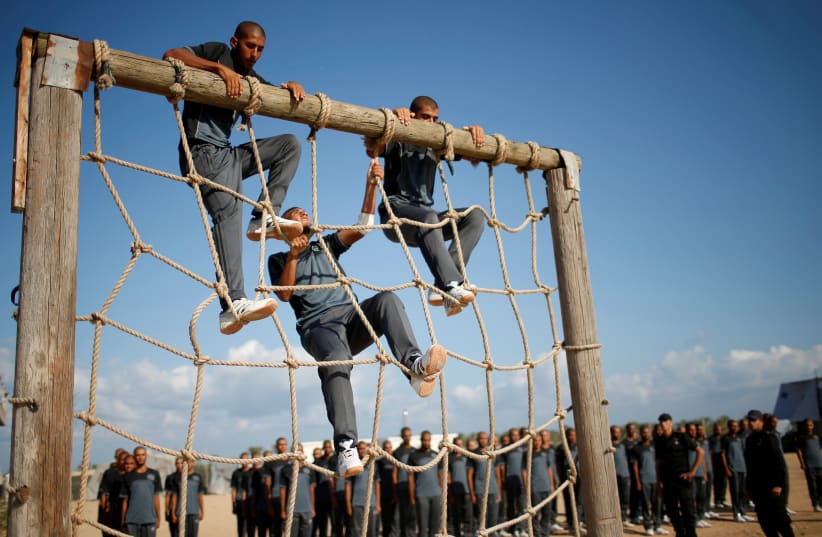  Palestinian Hamas policemen take part in a military training at Hamas-run police academy in Khan Younis in the southern Gaza Strip September 27, 2017. (photo credit: SUHAIB SALEM/REUTERS)