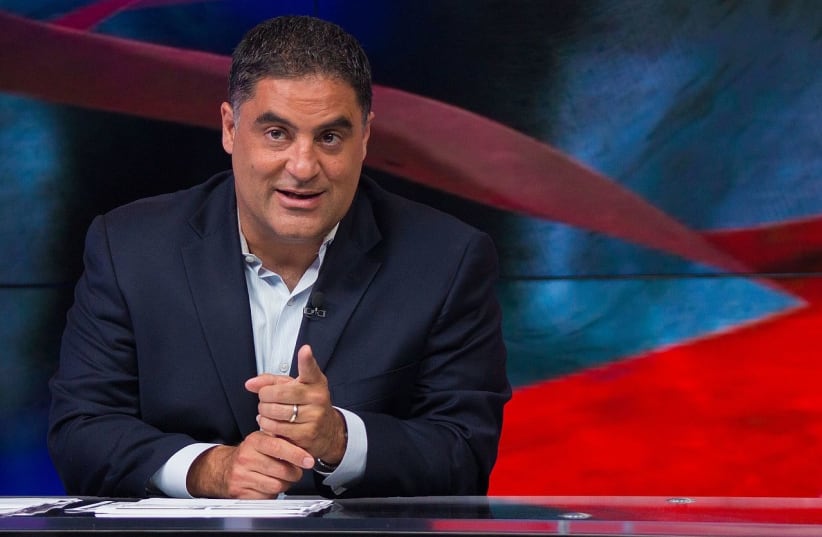 Cenk Uygur gesturing while hosting The Young Turks live streaming show on June 23, 2015. (photo credit: Wikimedia Commons)
