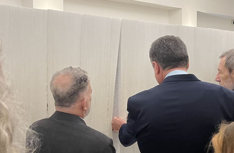 Brazilian ambassador and Foreign minister Israel Katz at Yad Vashem’s Book of Names. (photo credit: MICHAEL STARR)