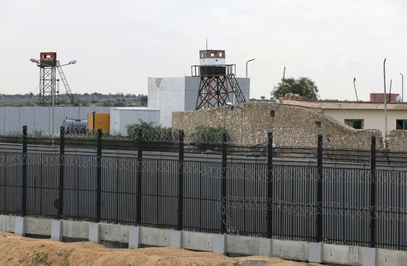  A BORDER FENCE separates the Gaza Strip and Egypt, at Rafah. From the Egyptian perspective, Israel taking control of the Philadelphi Corridor while ‘encouraging the migration of Gazans to Egypt,’ as several Israeli politicians have stated, constitutes a red line, says the writer. (photo credit: IBRAHEEM ABU MUSTAFA/REUTERS)