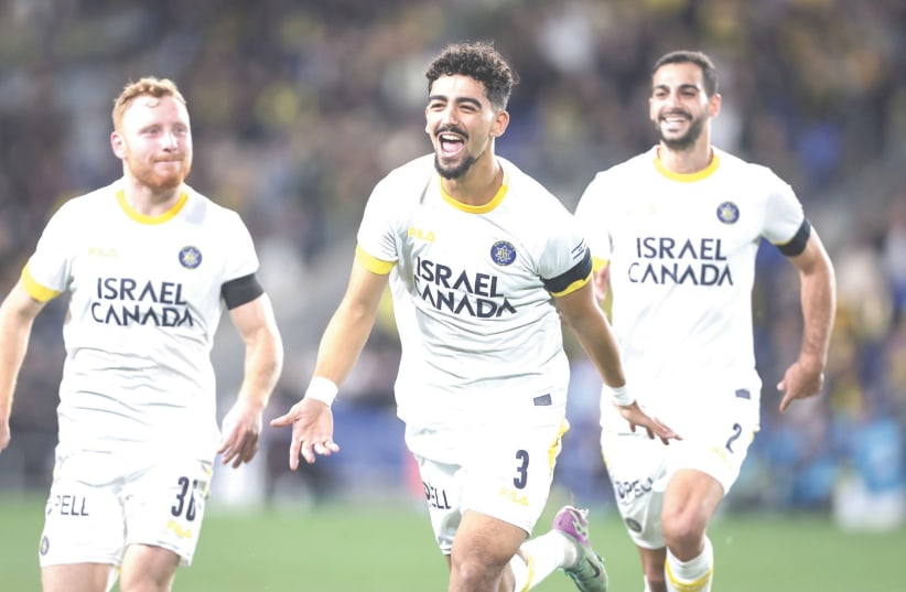  MACCABI TEL AVIV’S Roy Revivo (center) celebrates after scoring the yellow-and-blue’s second goal in their 5-1 road victory over Maccabi Netanya. (photo credit: MACCABI TEL AVIV/COURTESY)