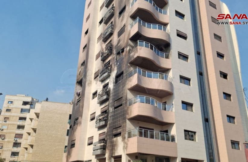  Una vista muestra un edificio dañado después de que, según informes de los medios de comunicación estatales sirios, varios misiles israelíes impactaran en un edificio residencial en el distrito de Kafr Sousa, Damasco, Siria 21 de febrero de 2024. (photo credit: REUTERS/SANA/HANDOUT VIA REUTERS)