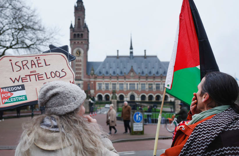 People protest on the day of a public hearing held by The International Court of Justice (ICJ) in The Hague, Netherlands, February 21, 2024 (photo credit: PIROSCHKA VAN DE WOUW/REUTERS)