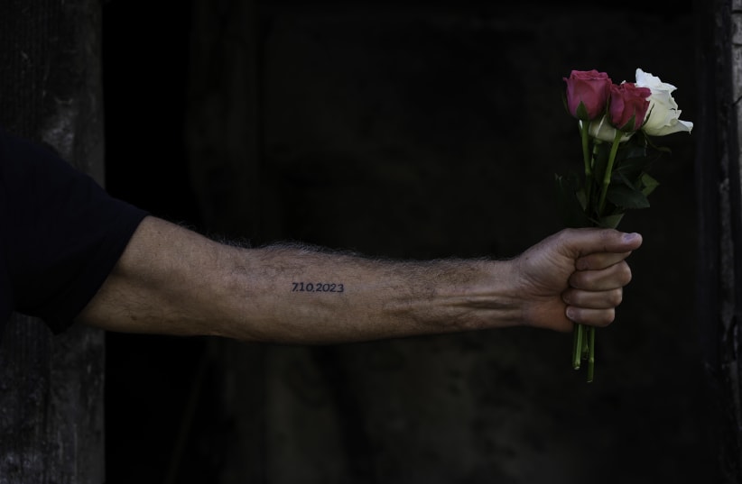  KIBBUTZ BE’ERI resident Haim Jelin reprises the numbers tattooed on prisoners at Auschwitz. (photo credit: EREZ KAGANOVITZ)
