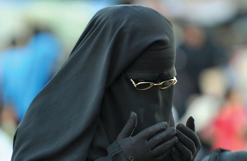  A NIQAB-CLAD woman prays in Cairo. (photo credit: Fayez Nureldine/AFP via Getty Images)