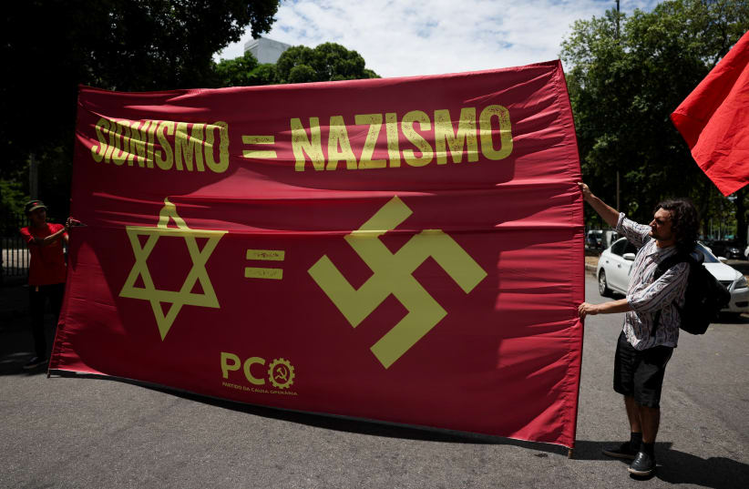  People hold a banner during a pro-Palestinian demonstration, amid a meeting of foreign ministers as part of Brazil's presidency of the G20, in Rio de Janeiro, Brazil February 22, 2024 (photo credit: REUTERS/PILAR OLIVARES)