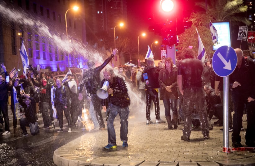    Police use a water cannon to disperse protesters during a protest against Israeli Prime Minister Benjamin Netanyahu and the current Israeli government, in Tel Aviv, on February 24, 2024 (photo credit: MIRIAM ALSTER/FLASH90)