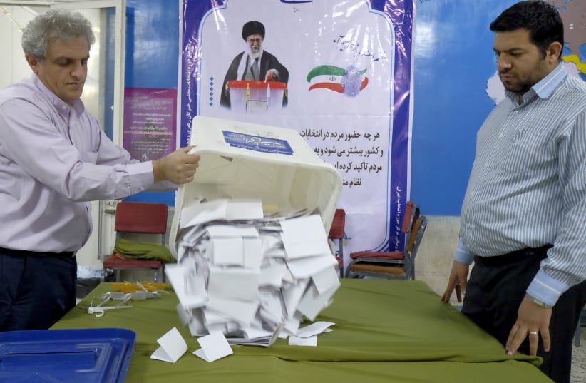  Election officials count ballot papers after the closure of polling stations during elections for the parliament and Assembly of Experts, which has the power to appoint and dismiss the supreme leader, in Tehran, Iran. February 26, 2016. (photo credit: Raheb Homavandi/TIMA/Reuters)
