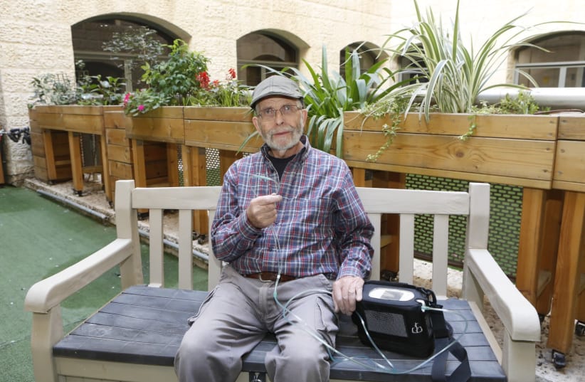  A man uses a portable oxygen concentrator issued by Yad Sarah.  (photo credit: YAD SARAH)