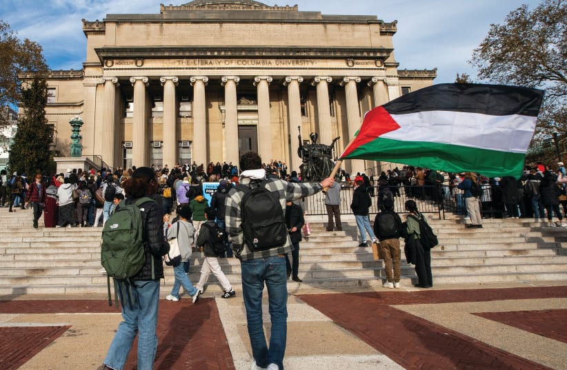  A PROTESTER waves a Palestinian flag during a rally at Columbia University in New York, in November.  (photo credit: Eduardo Munoz/Reuters)