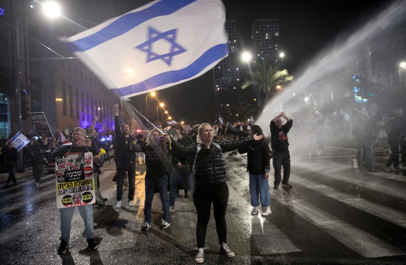  Police use a water cannon to disperse protesters during a protest against Israeli Prime Minister Benjamin Netanyahu and the current Israeli government, in Tel Aviv, on February 24, 2024. (photo credit: MIRIAM ALSTER/FLASH90)
