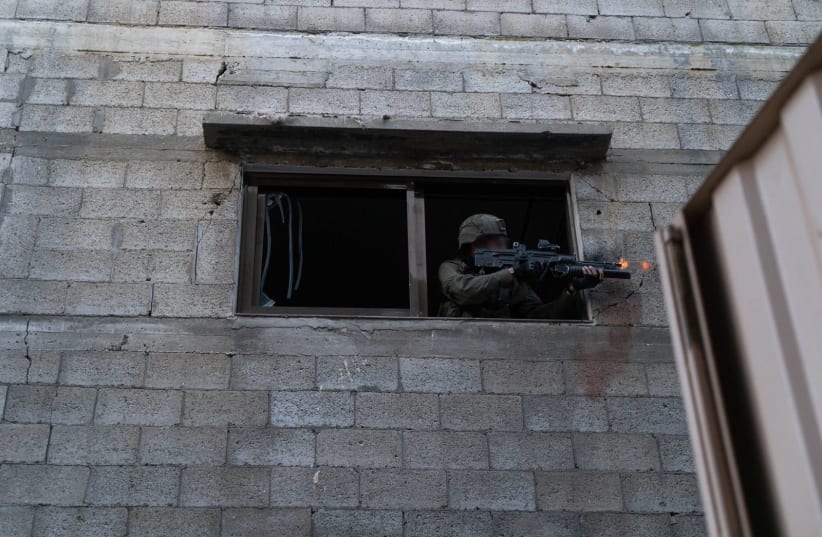  An IDF soldier fires from a building in northern Gaza. February 26, 2024. (photo credit: IDF SPOKESPERSON'S UNIT)