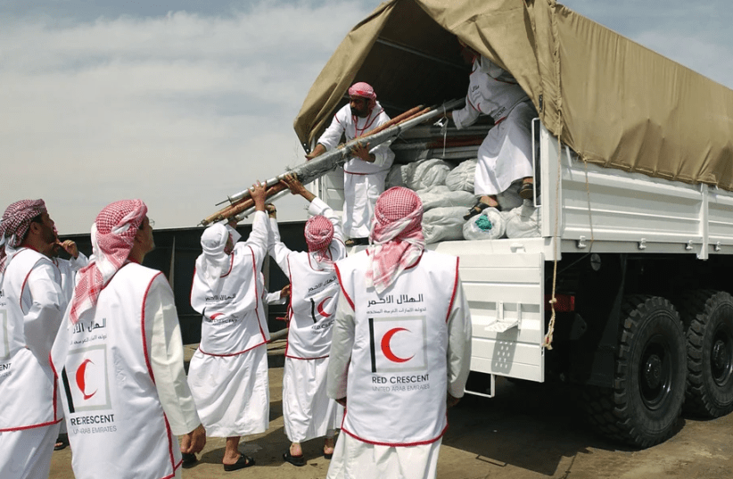  Members of the United Arab Emirates (UAE) Red Crescent Society load humanitarian aid and relief supplies onto a cargo truck, after the vehicle was checked for explosives, at the port of Umm Qasr Iraq, during Operation IRAQI FREEDOM (photo credit:  NARA & DVIDS Public Domain Archive)