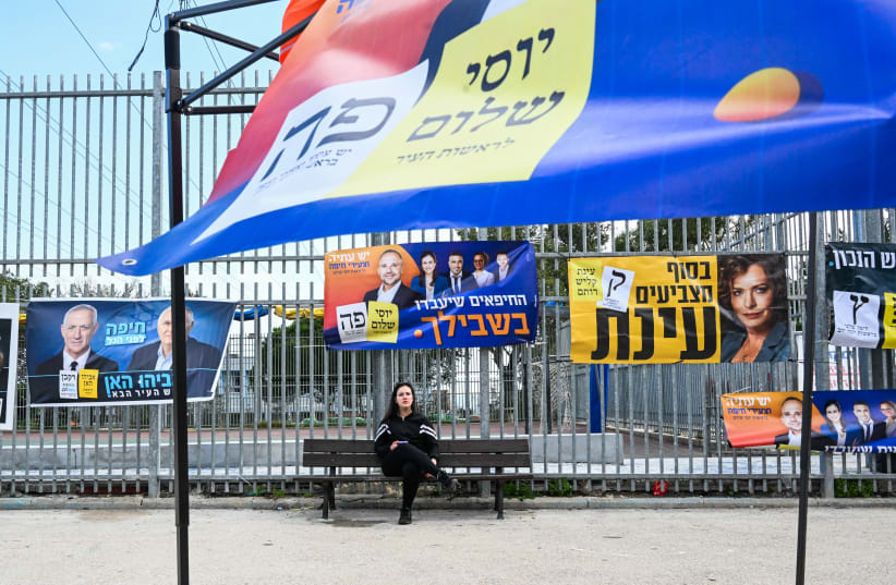  Campaign posters are seen at a voting booth in Haifa on the day of the municipal elections, on February 27, 2024. (photo credit: FLASH90)