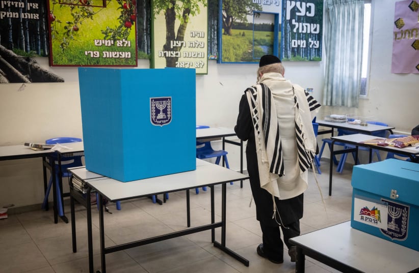  An ultra-orthodox Jewish man casts his ballot at a voting station, in Bnei Brak, on February 27, 2024. (photo credit: Chaim Goldberg/Flash90)