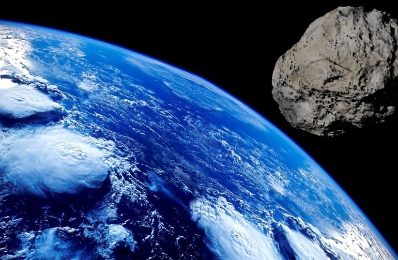  Un asteroide orbita alrededor de la Tierra en esta representación artística. (photo credit: PIXABAY)