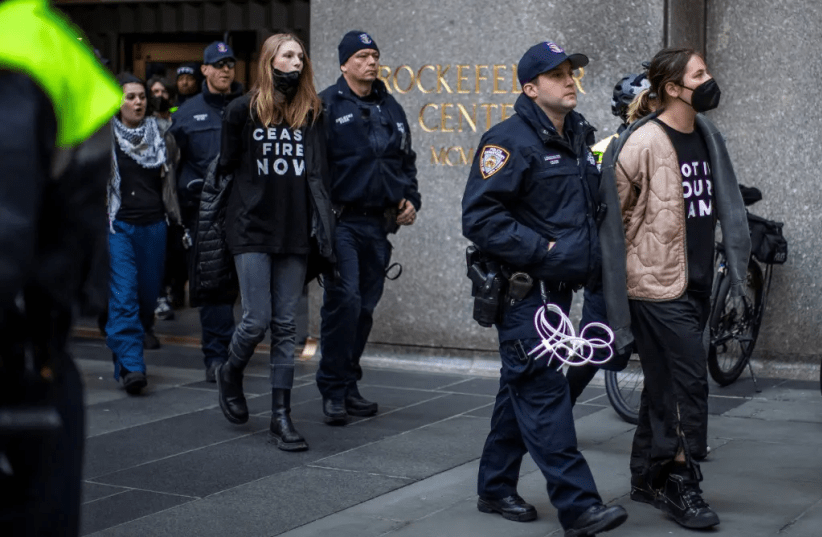  Hunter Schafer being arrested and escorted by police in NYC (photo credit: REUTERS)