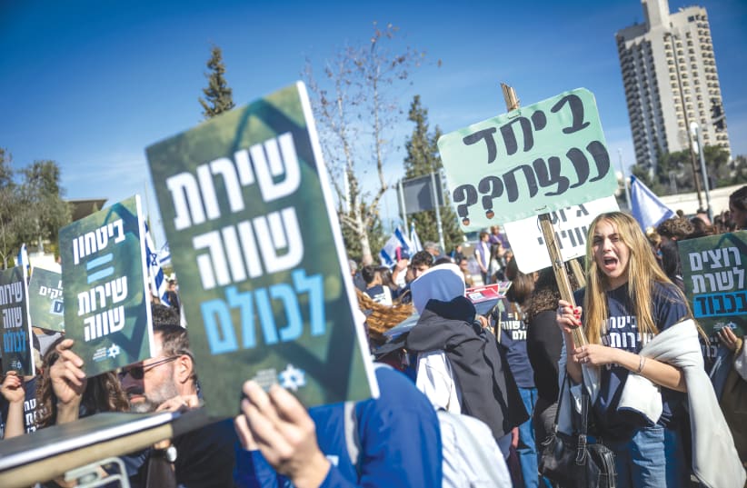  PROTESTERS AT a demonstration in Jerusalem on Monday call for the enlistment of haredim into the military. The placards carry such slogans as ‘Equal service for all.’ (photo credit: YONATAN SINDEL/FLASH90)