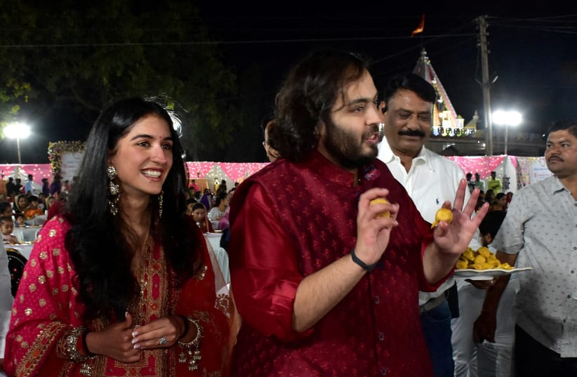  Anant Ambani, son of Mukesh Ambani, Chairman of Reliance Industries, and Radhika Merchant, daughter of industrialist Viren Merchant, serve traditional Gujarati food to villagers ahead of their pre-wedding celebrations on the outskirts of Jamnagar, Gujarat, India February 28, 2024 (photo credit: REUTERS/STRINGER/FILE PHOTO)