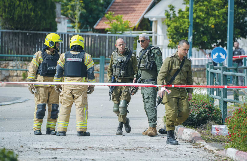  SECURITY FORCES are on the scene where a rocket fired from Lebanon wounded two people in Kiryat Shmona, last month.  (photo credit: AYAL MARGOLIN/FLASH90)
