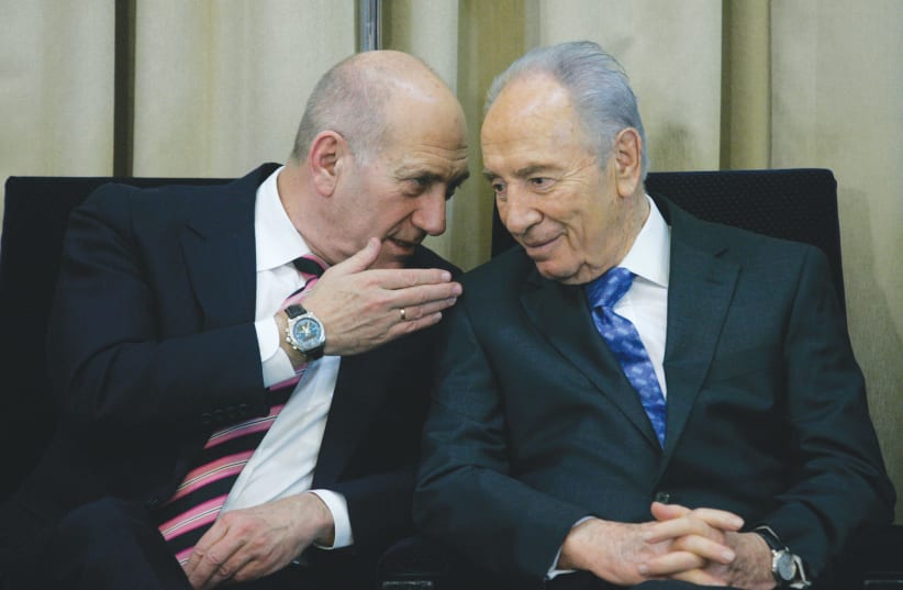  THEN-PRESIDENT Shimon Peres and then-prime minister Ehud Olmert attend a ceremony at the President’s Residence in Jerusalem, 2009. Peres and Olmert advocated for an agreement with the Palestinians and the Arab world, the writer notes. (photo credit: OLIVIER FITOUSSI/FLASH90)