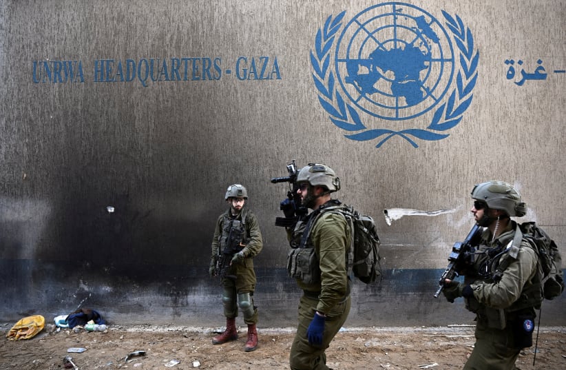  Israeli soldiers operate next to the UNRWA headquarters, amid the ongoing conflict between Israel and the Palestinian Islamist group Hamas, in the Gaza Strip, February 8, 2024.  (photo credit: DYLAN MARTINEZ/REUTERS)