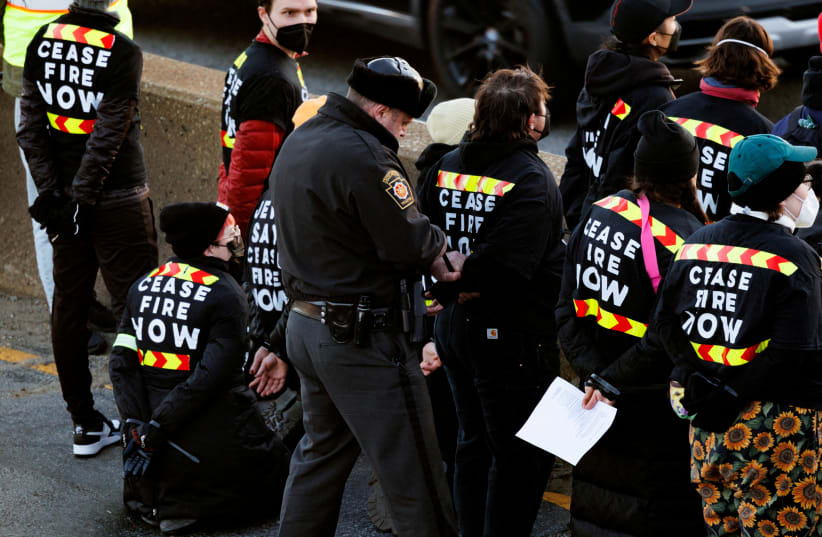  Protesters from the national group Jewish Voice for Peace are arrested for blocking traffic on I-76 during a call for a ceasefire in the Israel-Hamas war during rallies across the U.S. marking the 8th night of Hanukkah, in Philadelphia, Pennsylvania, U.S., December 14, 2023. (photo credit: Hannah Beier/Reuters)