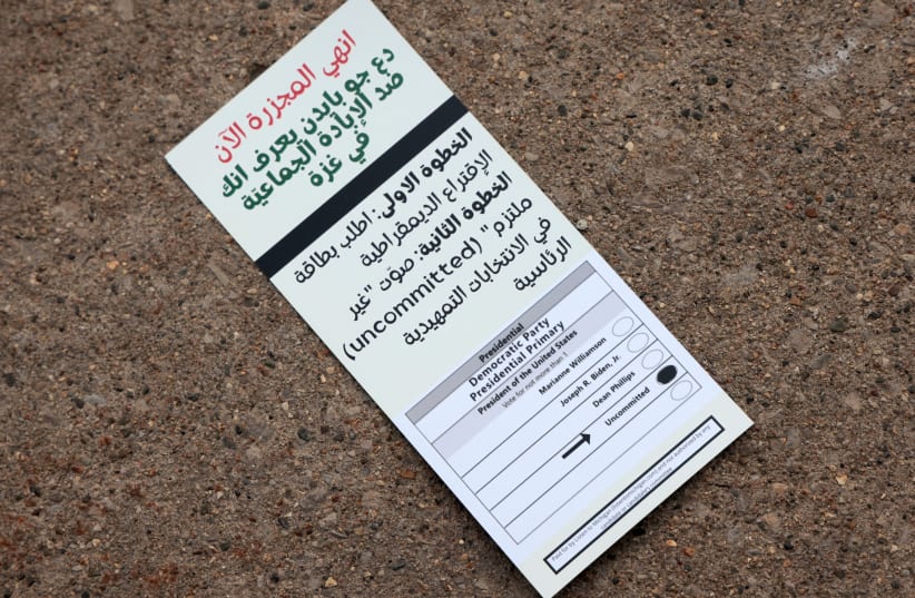  A flyer, written in Arabic, encourages voters to vote uncommitted outside a polling station as Democrats and Republicans hold their Michigan primary presidential election in Dearborn, Michigan, U.S. February 27, 2024 (photo credit: REUTERS/REBECCA COOK)