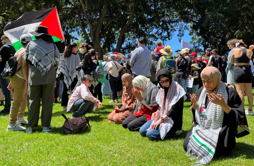 Women pray before a pro-Palestinian rally in Hyde Park, Sydney, Australia October 15, 2023. (photo credit: Reuters/Lewis Jackson)