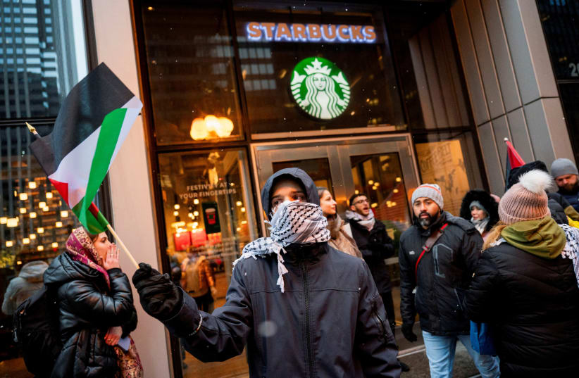 Activists of the group "Chicago Youth Liberation for Palestine" protest in support of Palestinians at a Starbucks, amid protests nationwide and calls for a ceasefire between Israel and Hamas, in Chicago, Illinois, U.S. December 31, 2023. (photo credit: Vincent Alban/Reuters)