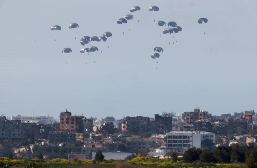  Packages fall towards Gaza, after being dropped from a military aircraft, amid the ongoing conflict between Israel and the Palestinian group Hamas, as seen from Israel's border with Gaza in southern Israel March 5, 2024.  (photo credit: AMIR COHEN/REUTERS)