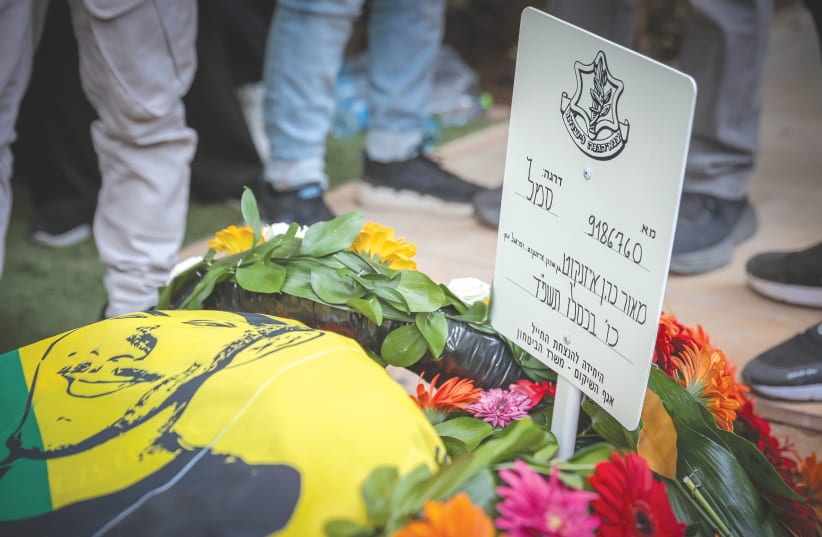  THE FRESH GRAVE of Sgt. Maor Cohen Eisenkot at his funeral in Eilat, in December. ‘I want to be a grandmother to a grandson from Maor. The end must be good,’ said his mother. (photo credit: NOAM REVKIN FENTON/FLASH90)