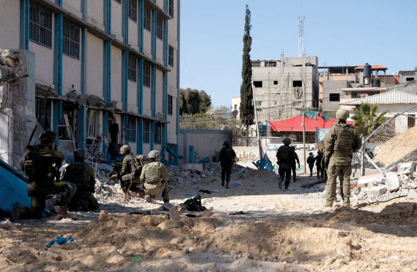   Israeli soldiers operate outside Nasser Hospital in Khan Yunis in this photograph released by the IDF on February 18, the date on which the hospital – one of the largest in the southern Gaza Strip – stopped functioning. (photo credit: IDF/Reuters)