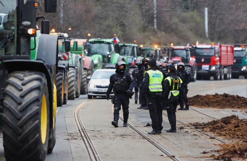  Farmers drive tractors in front of government office, where they dump manure, during a protest against European Union agricultural policies and grievances shared by farmers across Europe, in Prague, Czech Republic, March 7, 2024. (photo credit: REUTERS/EVA KORINKOVA)
