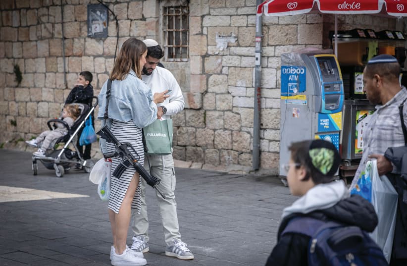  Shoppers are seen at the Mahane Yehuda market in Jerusalem. (photo credit: Chaim Goldberg/Flash90)