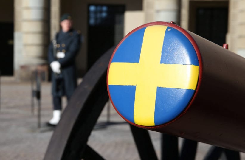  A Swedish soldier stands next to a ceremonial cannon in the courtyard of the Royal Palace in Stockholm, Sweden, March 7, 2024. (photo credit: TOM LITTLE/REUTERS)