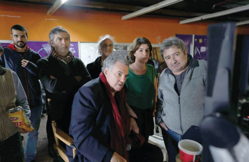  A BEHIND-THE-SCENES photo of ‘Shikun’ with Amos Gitai (center) and Irene Jacob (second from right).  (photo credit: Ziv Koren/United King Films)
