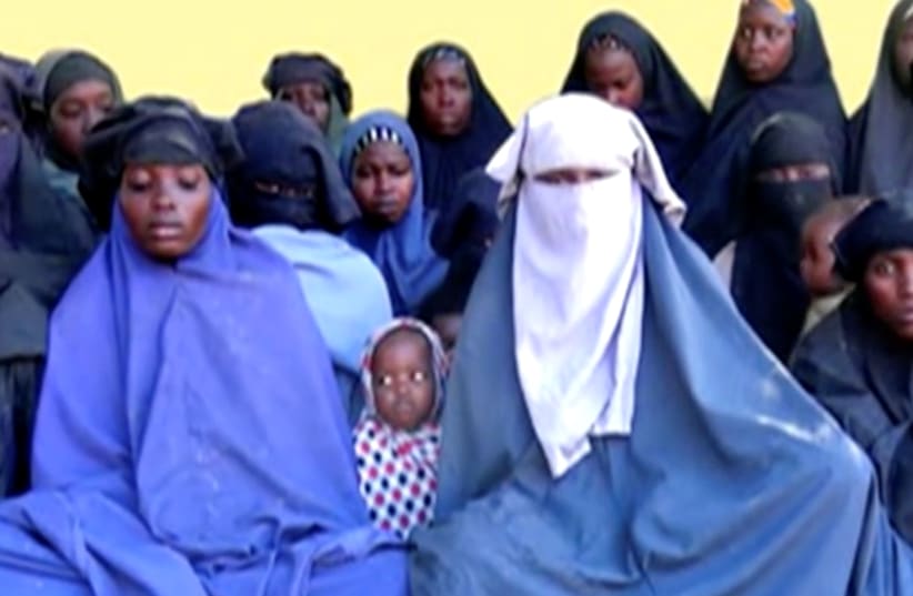  Remaining girls who were kidnapped from the northeast Nigerian town of Chibok are seen in an unknown location in Nigeria in this still image taken from an undated video obtained on January 15, 2018.  (photo credit: BOKO HARAM HANDOUT/SAHARA REPORTERS VIA REUTERS)