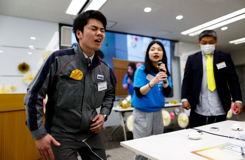  Masaya Shibasaki, 26, an employee of EXEO Group Inc., reacts as he tries the Osaka Heart Cool developed VR electrical device 'Perionoid' which releases electrical stimulation that feels like experiencing women's menstrual pain during a workshop Tokyo, Japan March 7, 2024. (photo credit: REUTERS/ISSEI KATO)