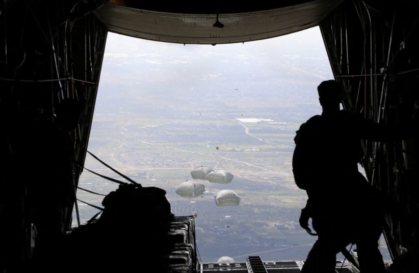  A picture released on March 7, 2024, by the Jordanian Armed Forces website shows what it said was aid being air-dropped over Gaza, in an operation it said was being carried out with the participation of Egypt, the United States, France, Netherlands and Belgium.  (photo credit: JORDAN ARMED FORCES/Handout via REUTERS)