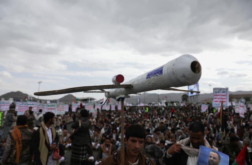  A protester carries a mock drone as demonstrators, predominantly Houthi supporters, rally to show support to the Palestinians in the Gaza Strip, amid the ongoing conflict between Israel and the Palestinian Islamist group Hamas, in Sanaa, Yemen February 16, 2024.  (photo credit: KHALED ABDULLAH/REUTERS)