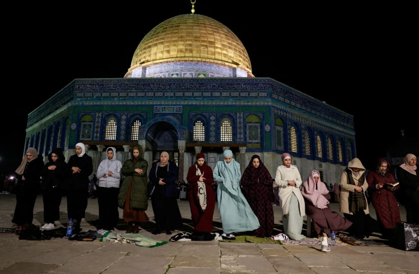  Fieles musulmanes participan en las oraciones vespertinas del "Tarawih" durante el mes sagrado musulmán del Ramadán, frente a la Cúpula de la Roca en el Monte del Templo, en la Ciudad Vieja de Jerusalén, el 10 de marzo de 2024. (photo credit: AMMAR AWAD/REUTERS)